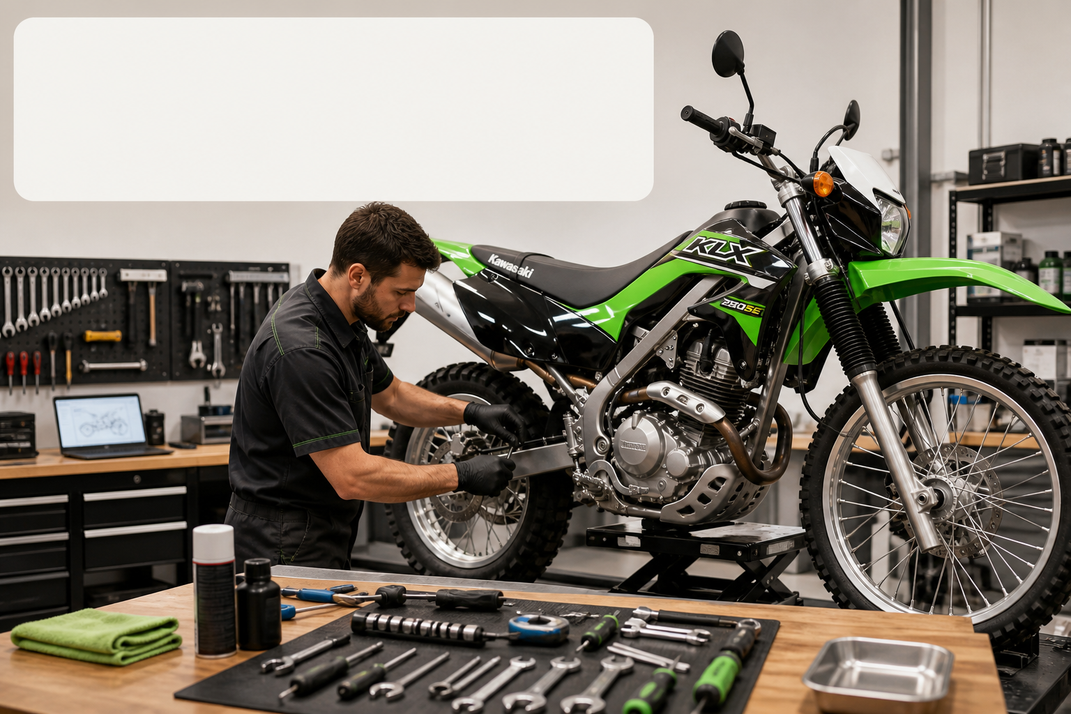 Professional motorcycle mechanic servicing Kawasaki KLX 230SE in clean workshop with tools laid out