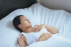 Woman sleeping with her mouth open, snoring