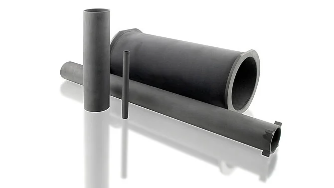Dark grey SiC tubes and pipes of varying diameters and lengths, as taken from CeramTec