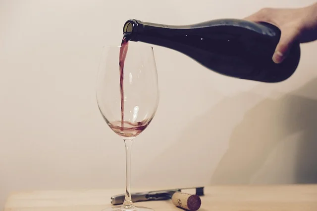 Ein Glas Rotwein wird eingeschenkt