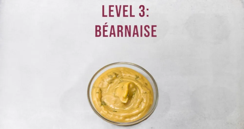 Bowl of béarnaise sauce with fresh tarragon