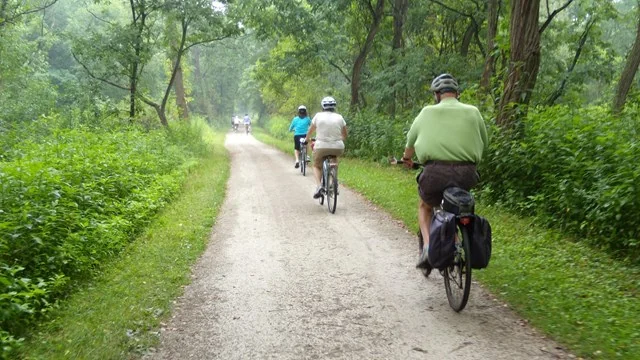 Three cyclists riding the Towpath Trail on a sunny summer day in CVNP
